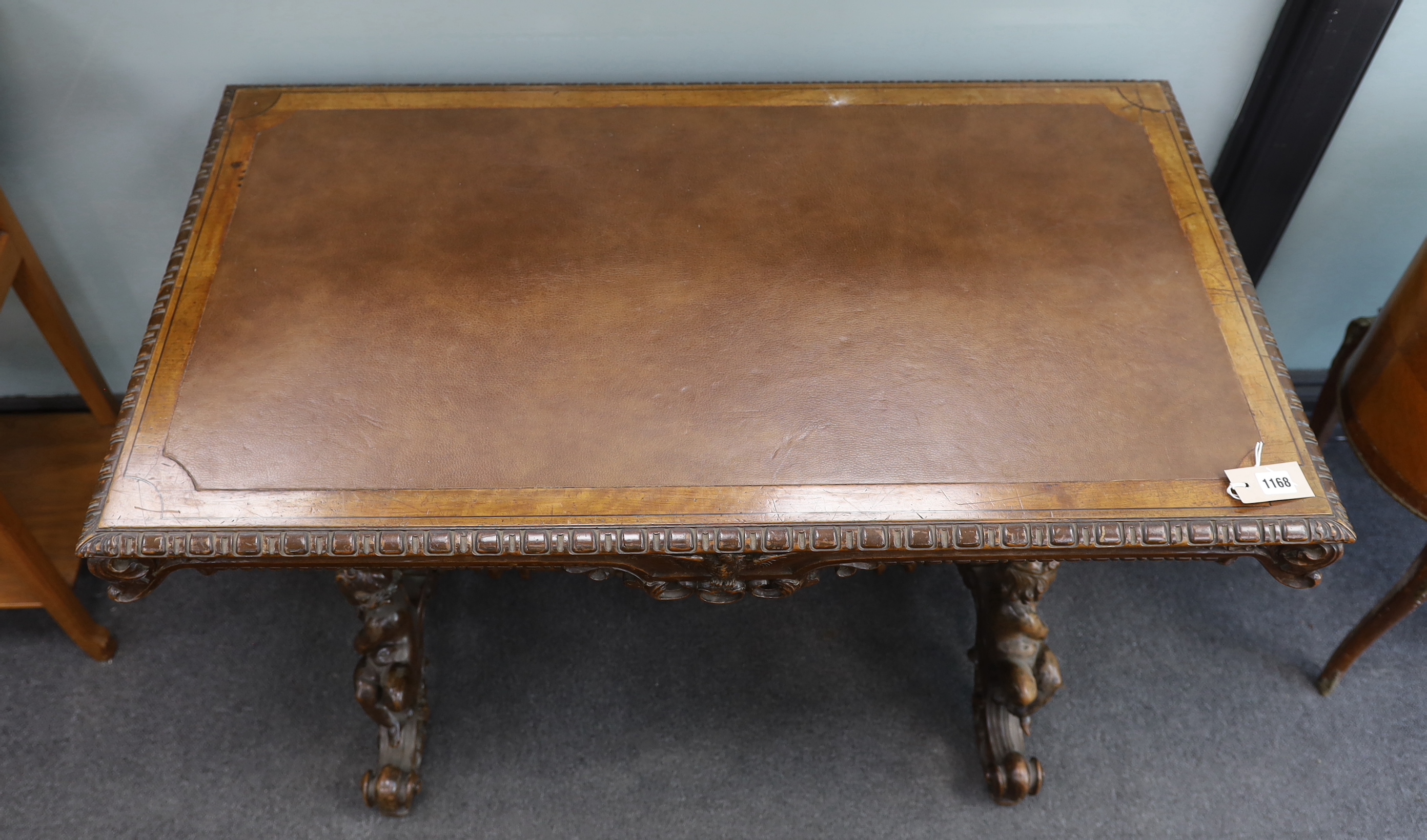A late 19th century rectangular continental carved walnut centre table with cherub underframe, width 106cm, depth 60cm, height 71cm